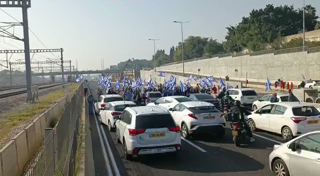 Israeli protesters block a major road in Tel Aviv ahead of the initial voting today in the Knesset on the judicial coup