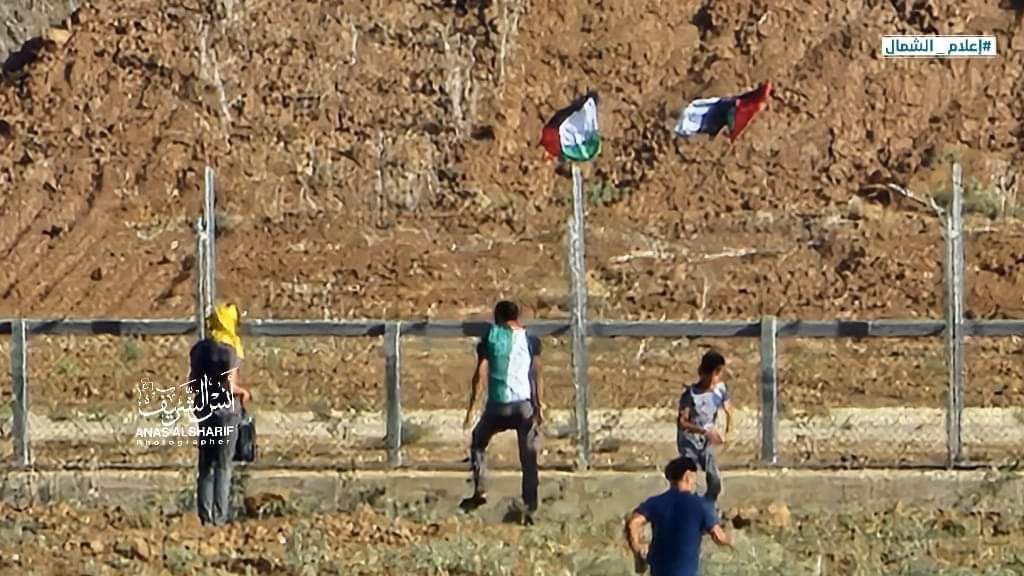 Palestinians are again rioting on the Gaza border, crossing into the buffer zone between the old fence and new fence, and placing Palestinian flags in the area, before running back into the Strip