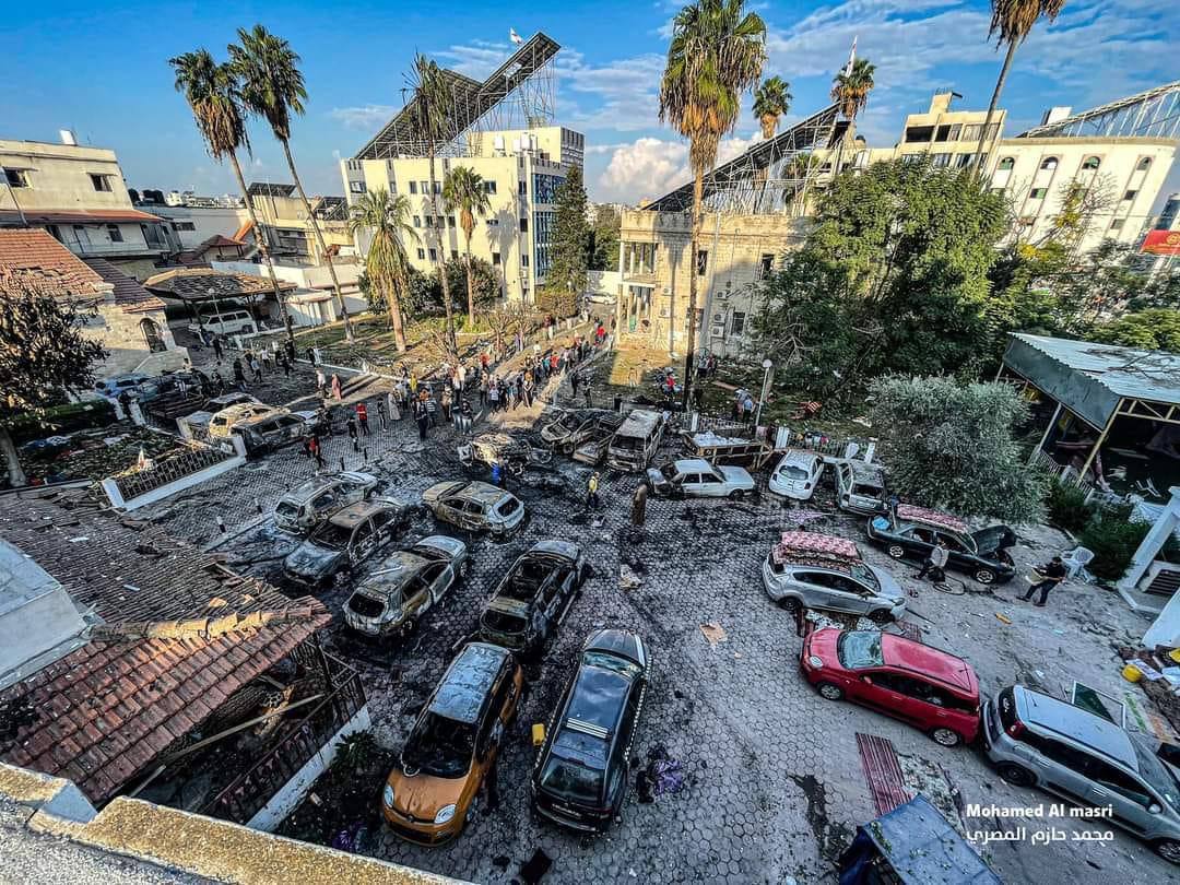 Image published by Palestinian media shows the aftermath of explosion in the parking lot of a hospital in Gaza. Surrounding buildings appear largely intact