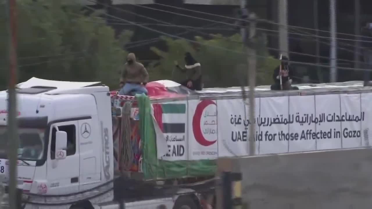 Aid trucks provided by the UAE guarded by what are likely members of Hamas police