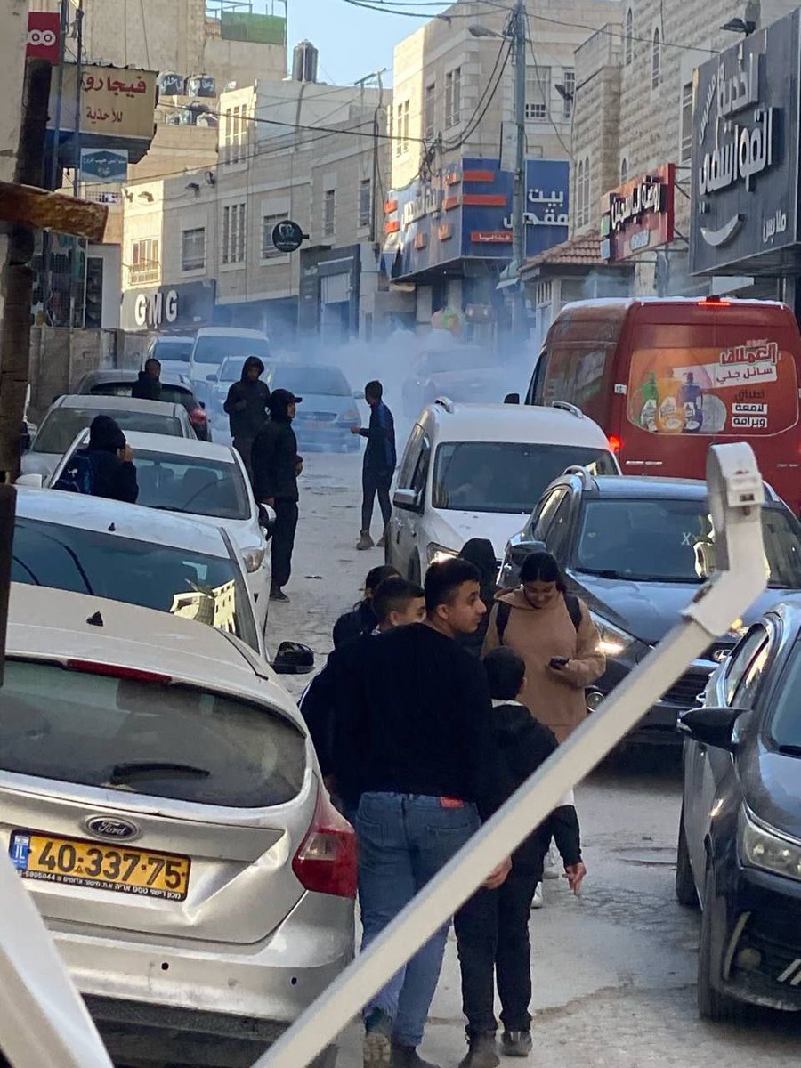 Israeli security forces storm Shuafat in Jerusalem and fire gas bombs as students return from their schools