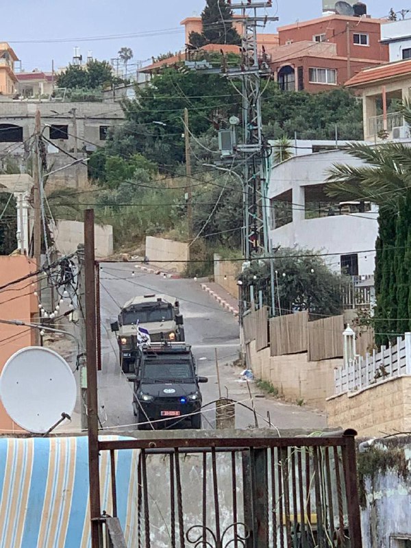 Israeli security forces storm a house in the town of Barta'a