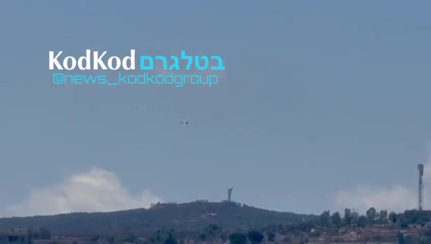 Fighter jets hover at a low altitude over the town of Aita al Shayab