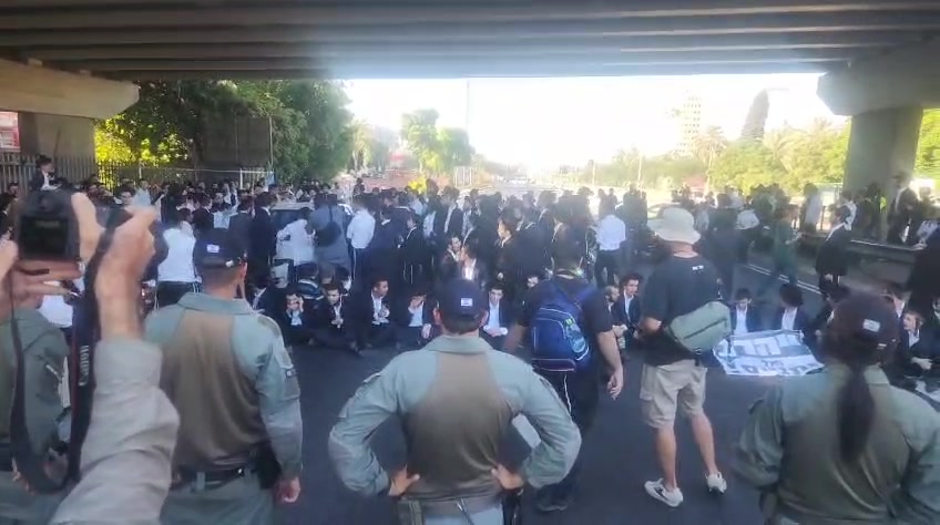 Dozens of ultra-Orthodox people block Highway 4 to the south near Bnei Brak, in protest of the conscription law. Photo: Shimon Baruch