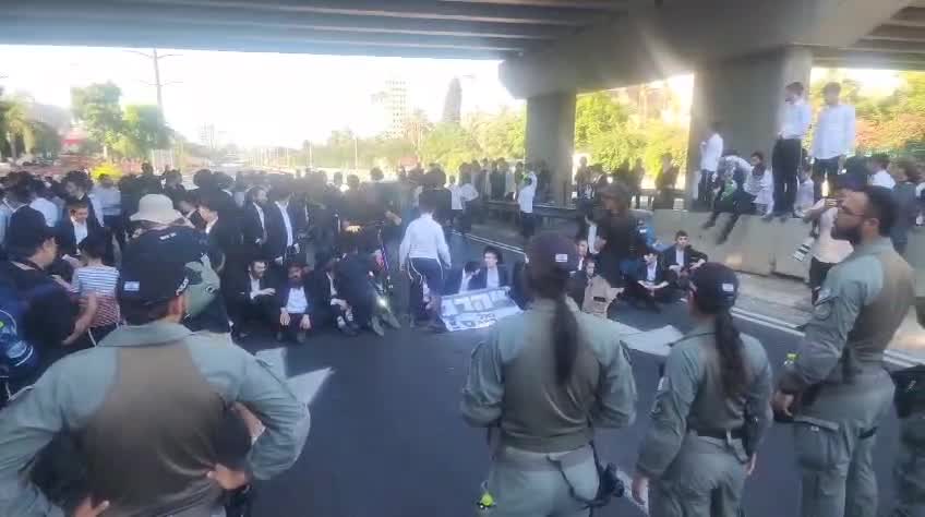 Dozens of ultra-Orthodox people block Highway 4 to the south near Bnei Brak, in protest of the conscription law. Photo: Shimon Baruch