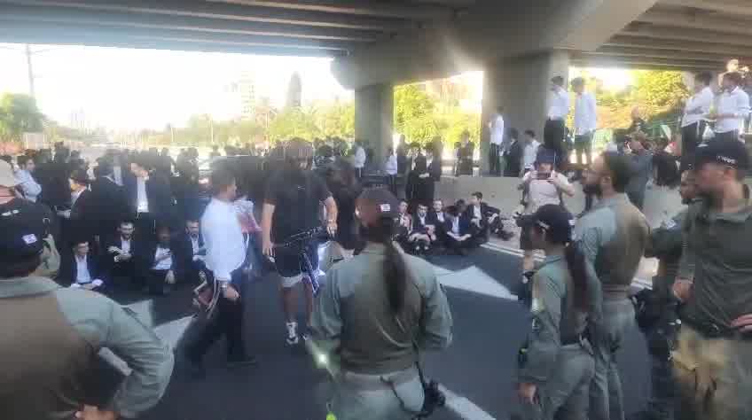 Dozens of ultra-Orthodox people block Highway 4 to the south near Bnei Brak, in protest of the conscription law. Photo: Shimon Baruch