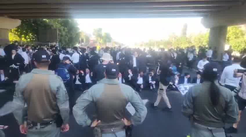 Dozens of ultra-Orthodox people block Highway 4 to the south near Bnei Brak, in protest of the conscription law. Photo: Shimon Baruch