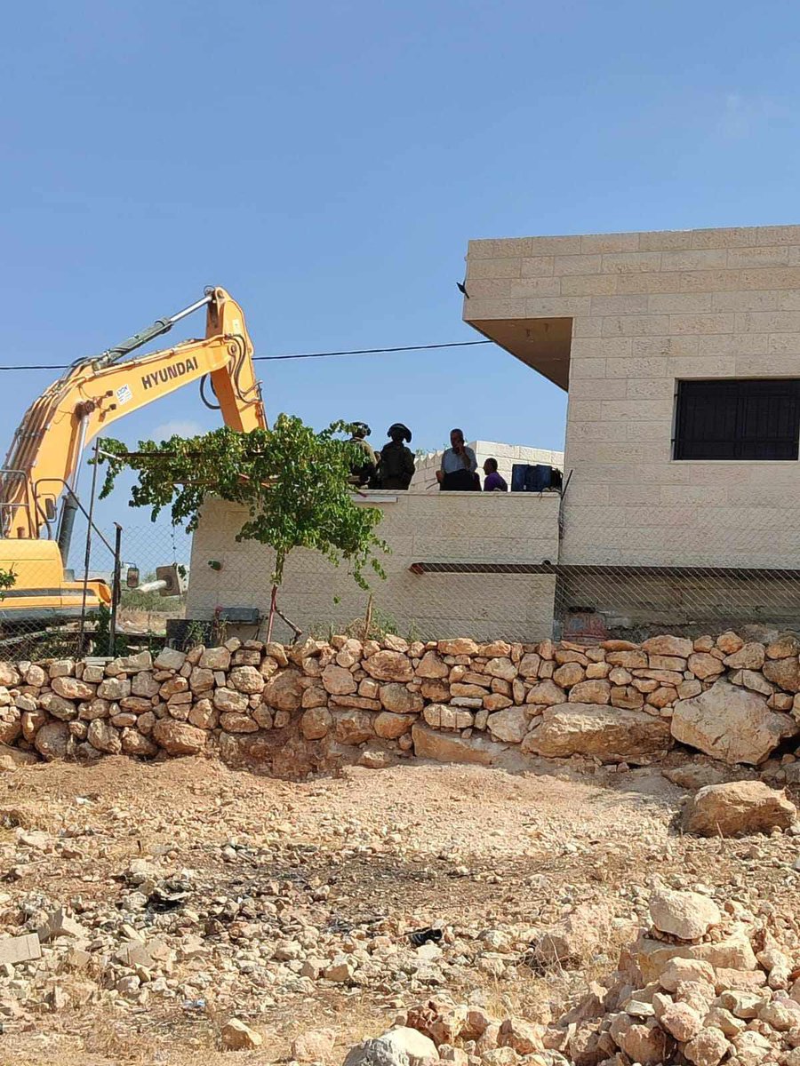 Bulldozers begin demolishing two houses in the village of Kharbatha al-Misbah, southwest of Ramallah