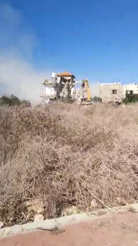 Tratores demolindo uma casa na vila de Tura, a oeste da cidade de Jenin