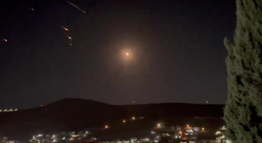 What appears to be ballistic missiles fired from Iran coming down on Israel