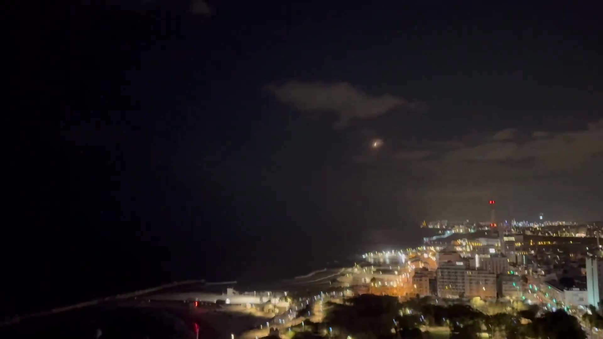 Multiple missile interceptors fly over Tel Aviv - followed by explosions over the Mediterranean Sea