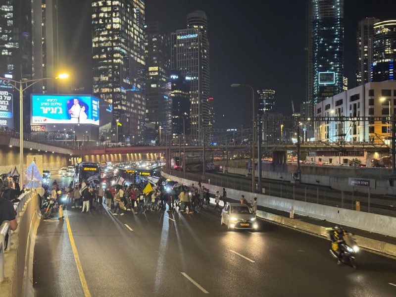 Protests into the firing of Minister of Defense Yoav Gallant have begun in Tel Aviv, with Demonstrators currently blocking the Shalom Interchange