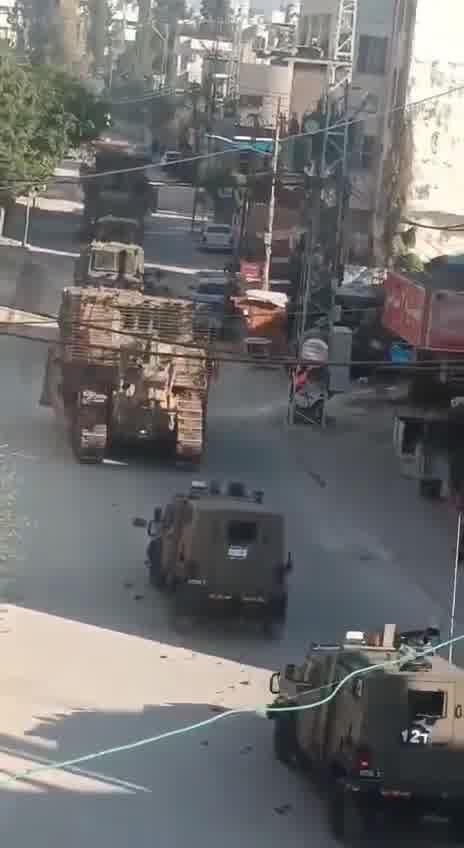 Palestinian media report clashes between Israeli forces and local militants in the West Bank's Tulkarm, amid circulating footage of robust deployment of Israeli army troops in the area. Reports of Israeli forces besieging the Tulkarm camp and heavy machinery demolishing infrastructure