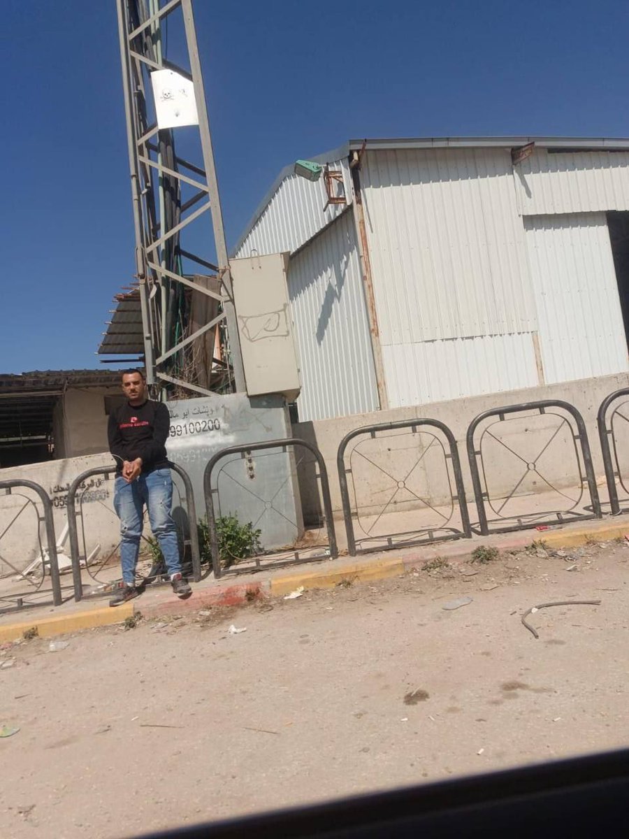 Forces detain a young man at the Deir Sharaf checkpoint, northwest of Nablus.