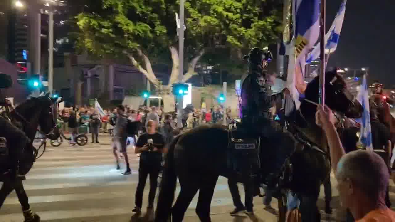 A march that left the Habima demonstration toward Ayalon was stopped on Begin Road by police and horsemen. Two protesters who were sitting on the road and refused to move were arrested. One of the horsemen whipped Haaretz photographer Itai Ron with the reins, in the footage wearing a white shirt and hat. Photo: Yair Palti