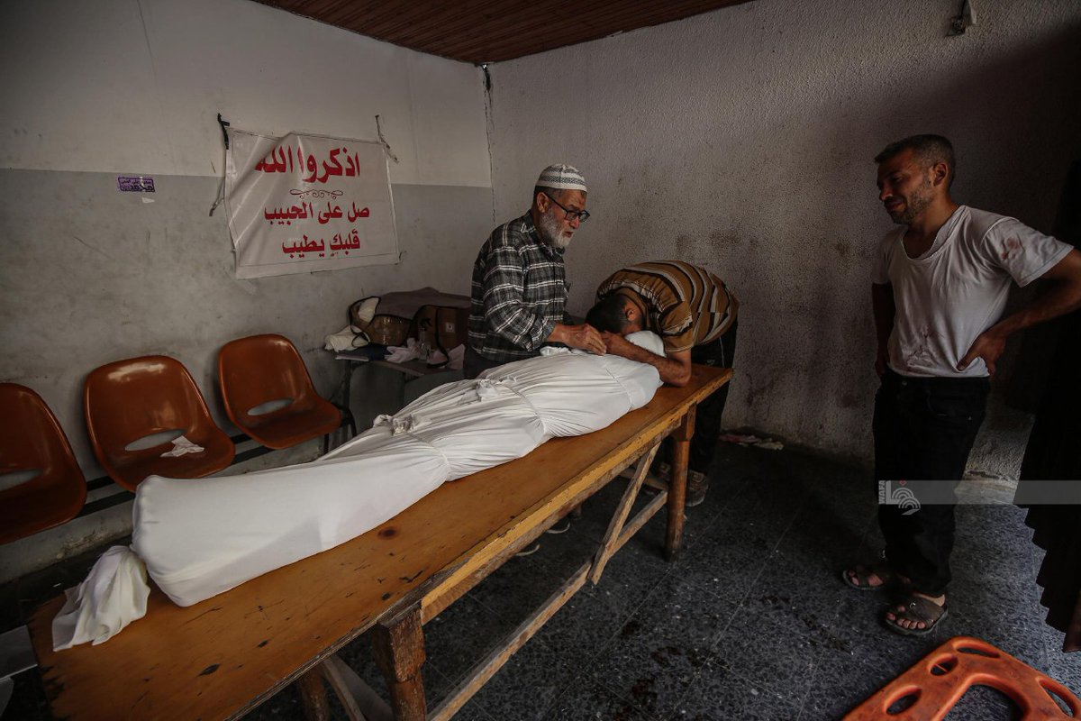Palestinians bury the bodies of a number of dead killed in airstrikes on Al-Hurriya School in the Al-Zeitoun neighborhood, south of Gaza City.