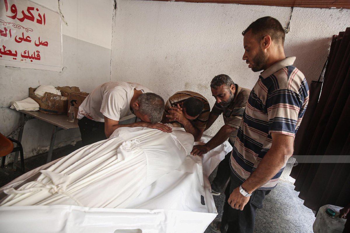 Palestinians bury the bodies of a number of dead killed in airstrikes on Al-Hurriya School in the Al-Zeitoun neighborhood, south of Gaza City.