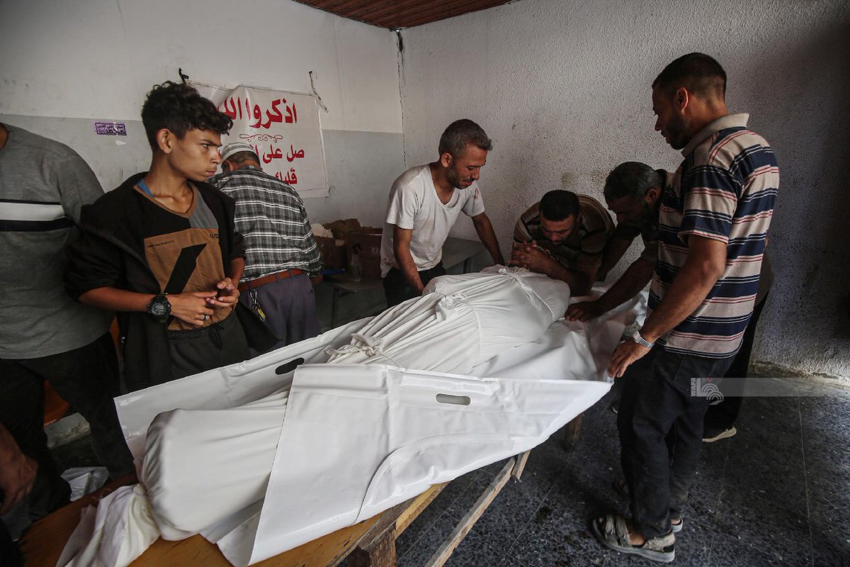 Palestinians bury the bodies of a number of dead killed in airstrikes on Al-Hurriya School in the Al-Zeitoun neighborhood, south of Gaza City.