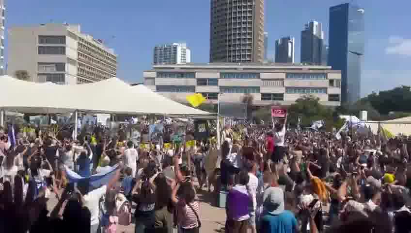 A helicopter carrying freed hostages flies over Hostage Square, greeted by thunderous applause from tens of thousands of Israelis gathered below