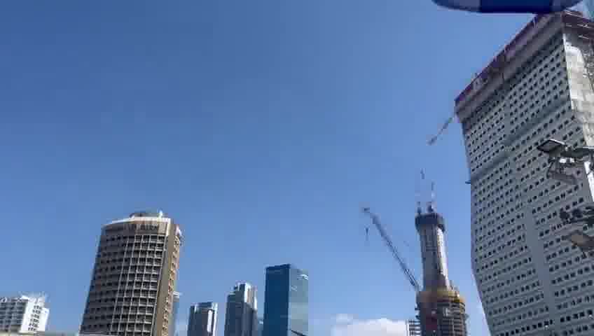 A helicopter carrying freed hostages flies over Hostage Square, greeted by thunderous applause from tens of thousands of Israelis gathered below