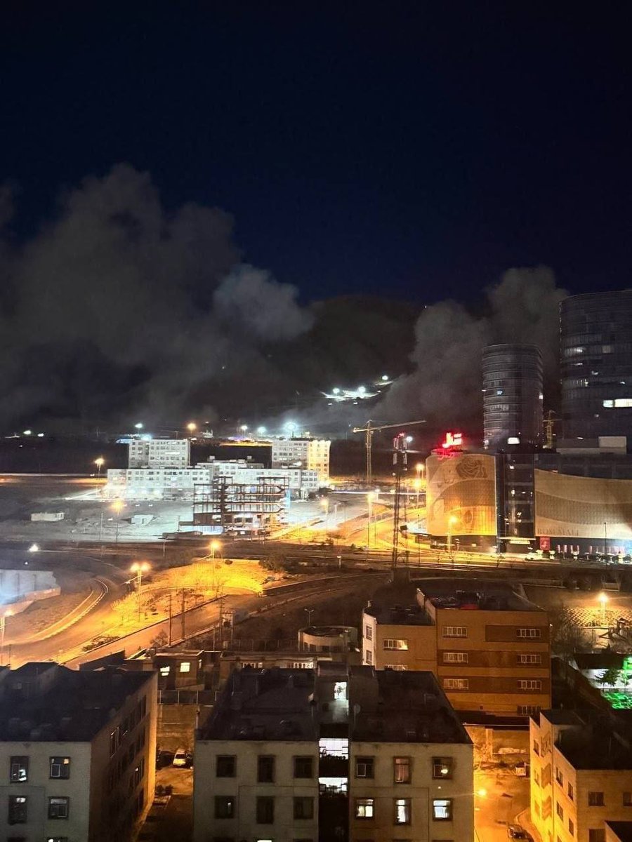 A photo shows several U.S./Israeli strikes in northern Tehran, behind the “Rose Mall,” about ten minutes ago