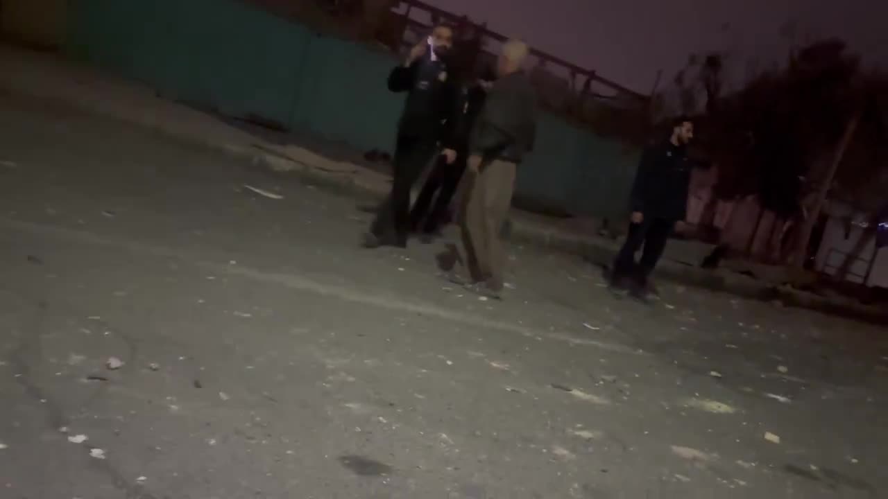 Residents in the Bisim district in south-east Tehran inspect the aftermath of a strike targeting the local police station, the roof of which appears to have been destroyed
