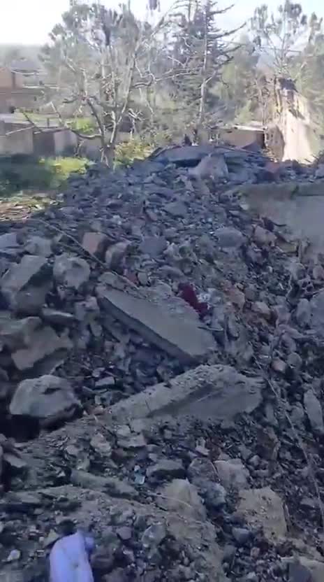 Destruction caused by the airstrike that targeted a house in the town of Al-Duwayr