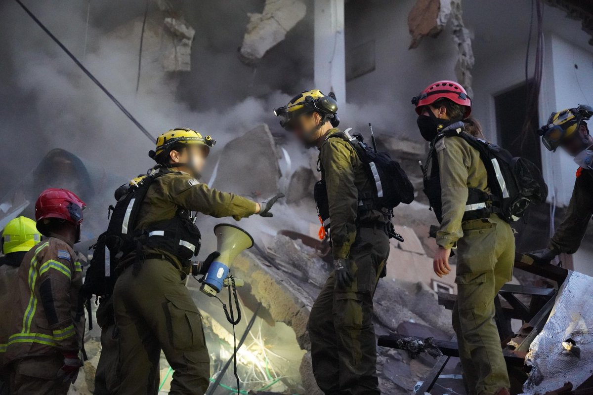 Four people are still unaccounted for and believed to be trapped under the rubble at the site of an Iranian ballistic missile impact in Haifa, Israel Police Commissioner Danny Levy tells reporters at the scene. We are focusing all efforts on the four family members who are supposed to be here, using all means at our disposal, he says. Levy also says that the warhead of the ballistic missile that struck the residential building may not have exploded upon impact, and therefore we evacuated several buildings, so that in the unlikely case that the missile explodes, nobody will be hurt.