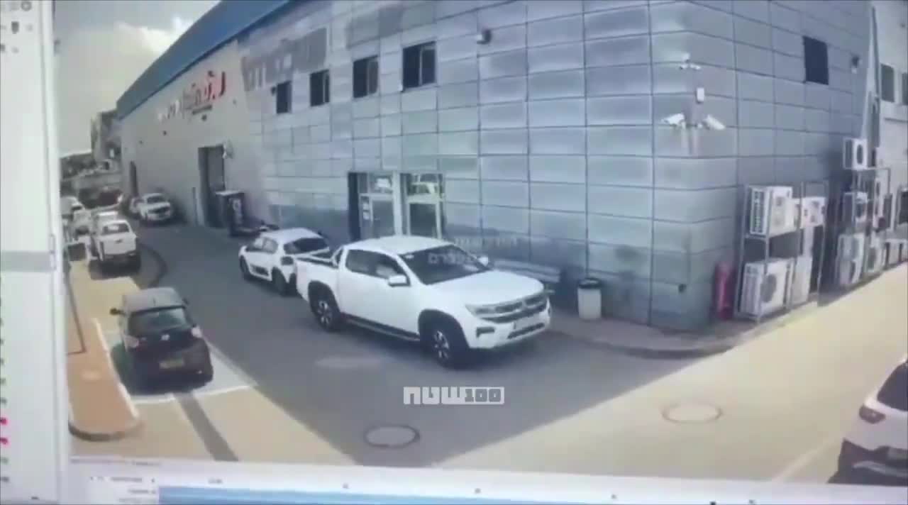 Video shows the moment when cluster submunitions from an Iranian missile struck a commercial area in Petah Tikva, Israel