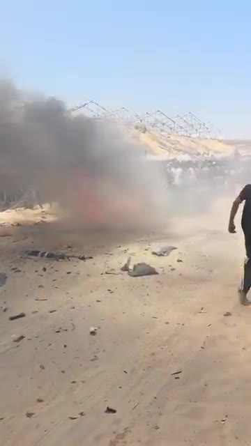 The first moments of the airstrike that targeted a civilian Jeep vehicle on Al-Tina Street, north of Khan Yunis city.