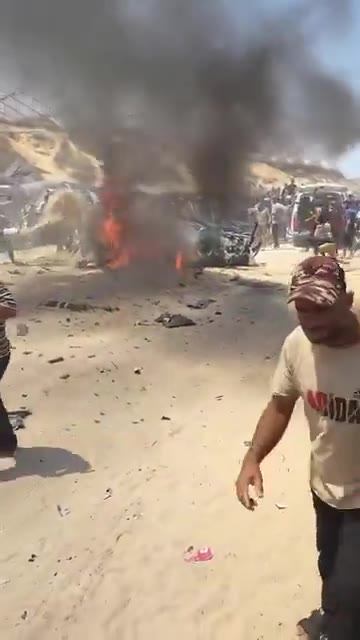 The first moments of the airstrike that targeted a civilian Jeep vehicle on Al-Tina Street, north of Khan Yunis city.