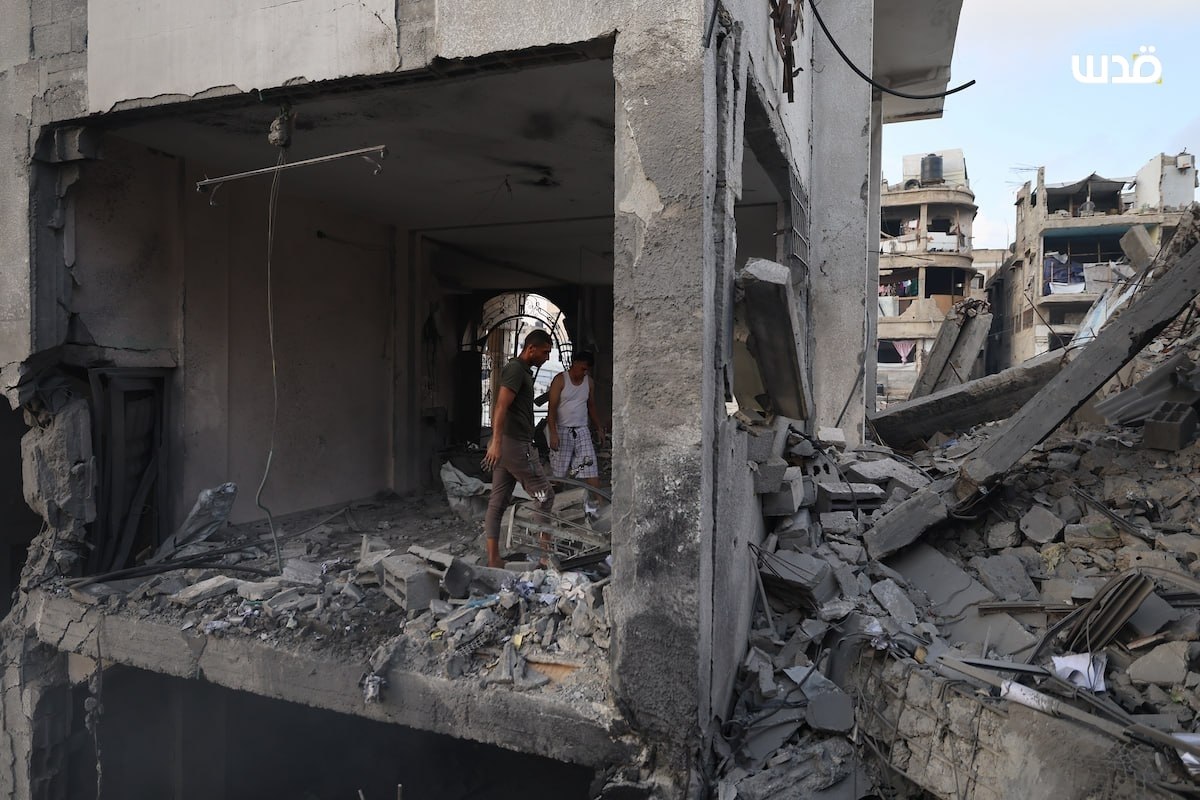 Palestinians inspect the damage to a building following an Israeli airstrike last night that targeted Al-Jalaa Street in the center of Gaza City.